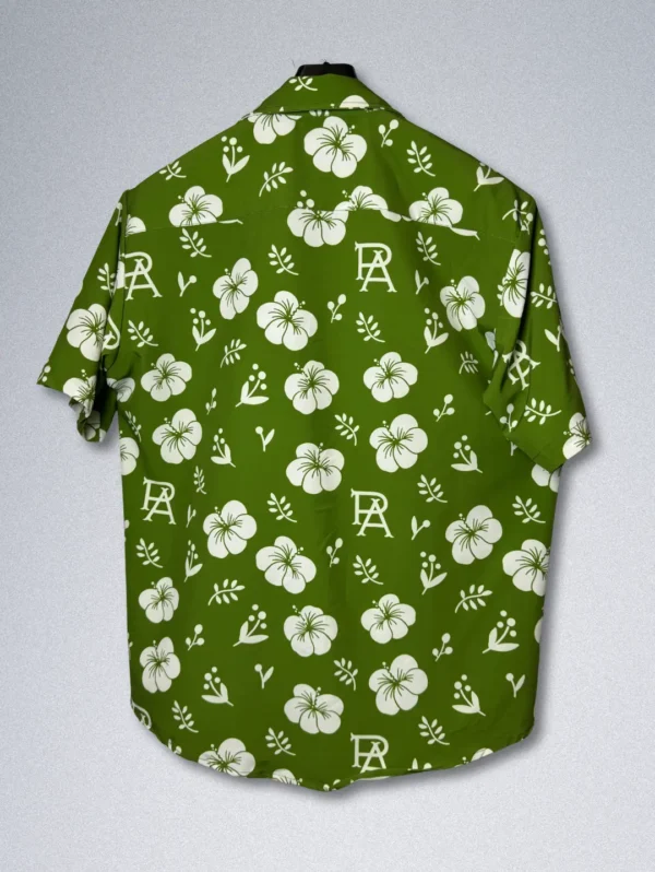 Men's FPS Apparel Tropical Monogram Silk Shirt, a green short-sleeve button-down with a white floral print and a subtle FPS logo pattern.