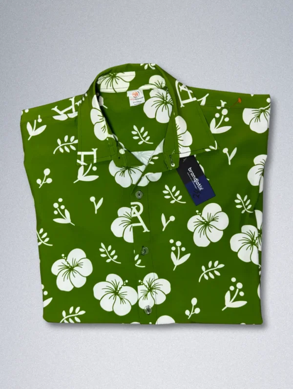 Men's FPS Apparel Tropical Monogram Silk Shirt, a green short-sleeve button-down with a white floral print and a subtle FPS logo pattern.