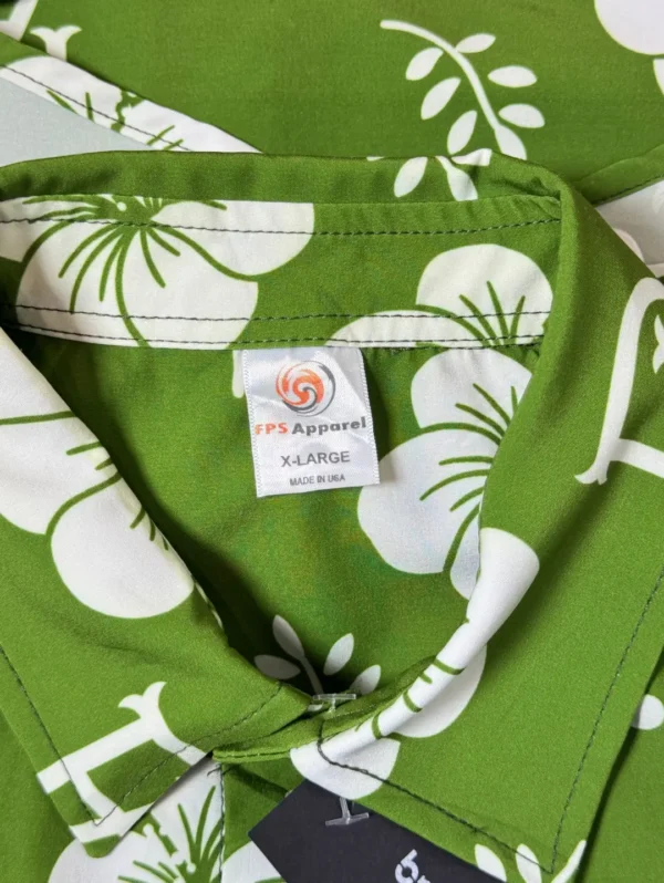 Men's FPS Apparel Tropical Monogram Silk Shirt, a green short-sleeve button-down with a white floral print and a subtle FPS logo pattern.