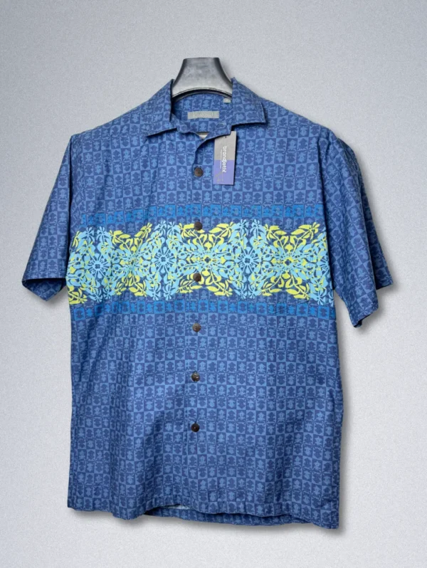 Men's Koa Road Horizon Cotton Shirt, a blue button-down with a horizontal band of yellow and light blue floral patterns across the chest.