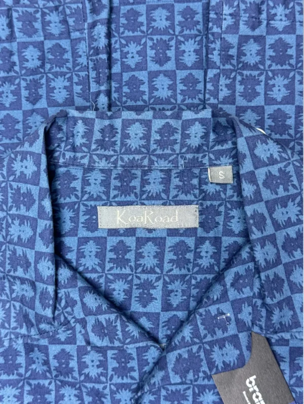 Men's Koa Road Horizon Cotton Shirt, a blue button-down with a horizontal band of yellow and light blue floral patterns across the chest.