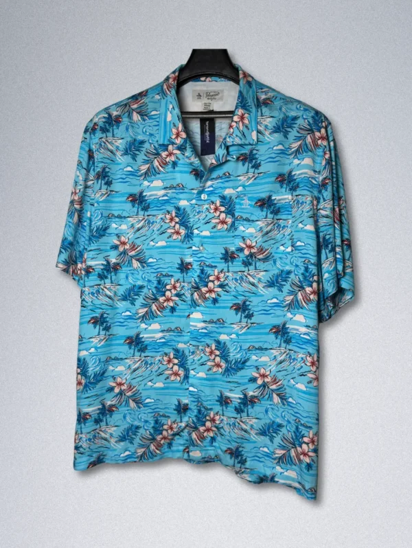 Men's Penguin Tropical Rayon Shirt, a blue short-sleeve button-down with a print of tropical flowers, palm trees, and sailboats.