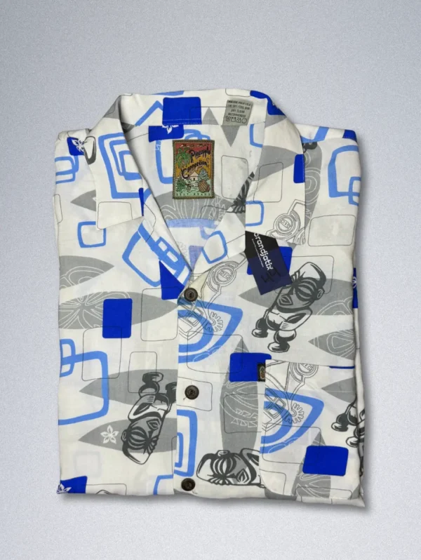 Pineapple Connection Rayon Shirt - Men's short-sleeve button-down with an abstract print of blue squares, gray shapes, and stylized tiki masks and surfboards on a white background.