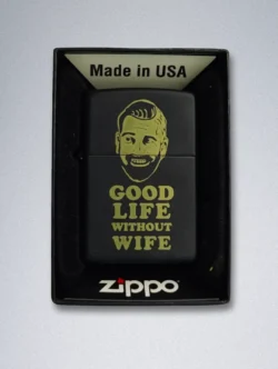 A matte black Zippo lighter with a gold graphic of a smiling, bearded man and the text "GOOD LIFE WITHOUT WIFE".