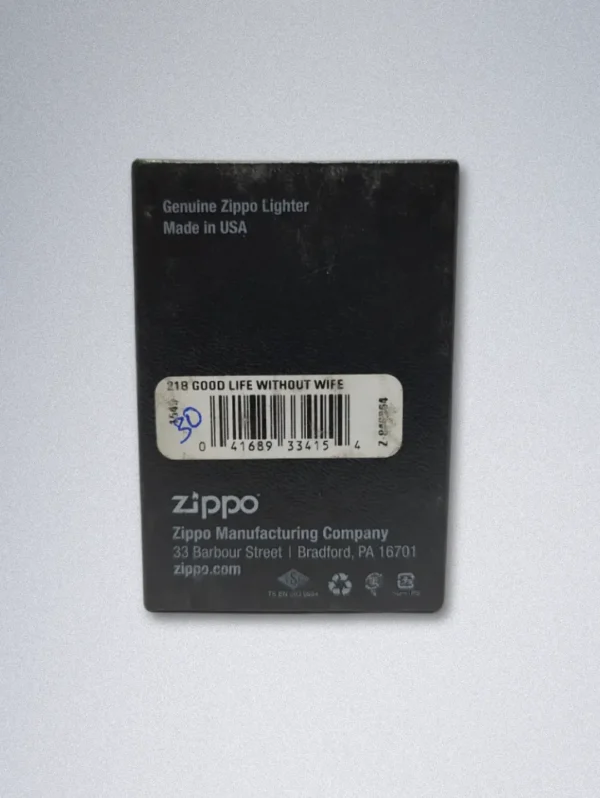 A matte black Zippo lighter with a gold graphic of a smiling, bearded man and the text "GOOD LIFE WITHOUT WIFE".