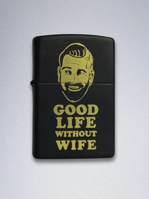 A matte black Zippo lighter with a gold graphic of a smiling, bearded man and the text "GOOD LIFE WITHOUT WIFE".