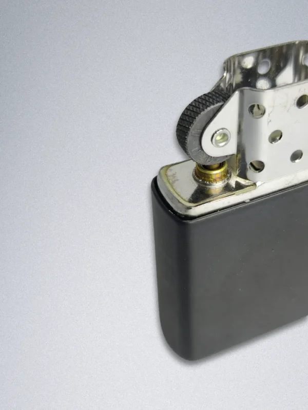 A matte black Zippo lighter with a gold graphic of a smiling, bearded man and the text "GOOD LIFE WITHOUT WIFE".