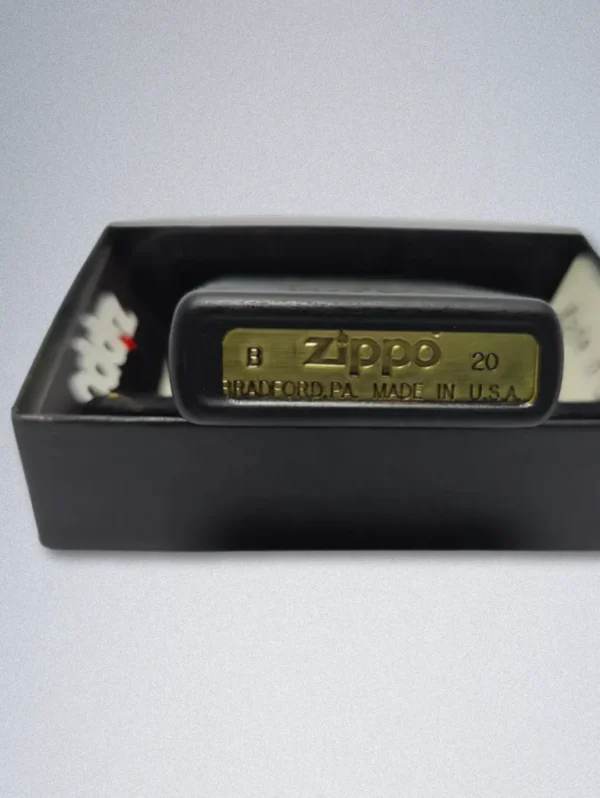 A matte black Zippo lighter with a gold graphic of a smiling, bearded man and the text "GOOD LIFE WITHOUT WIFE".