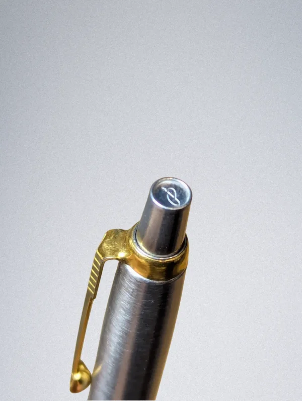 Genuine Parker ballpoint pen with a burgundy barrel, stainless steel cap, and gold arrow clip.