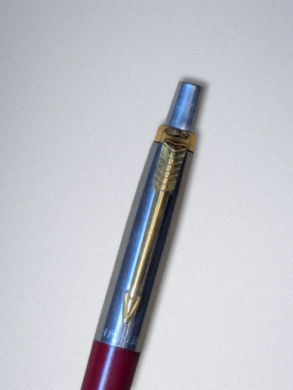 Genuine Parker ballpoint pen with a burgundy barrel, stainless steel cap, and gold arrow clip.
